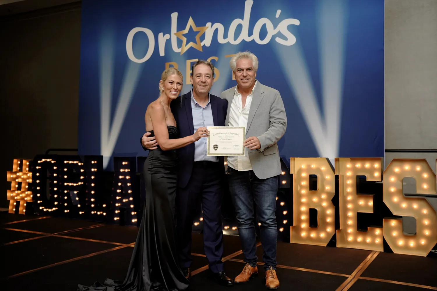 The Attica Air Duct Cleaners team accepting the 2026 Orlando's Best Gold award on stage